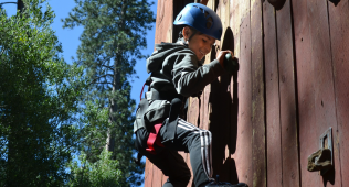 Kid climbing at camp